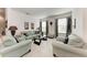 Comfortable living room with tile flooring, neutral furniture, and abundant natural light at 5811 Campina Pl, Palmetto, FL 34221