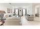 Bright and open living room featuring neutral tones, tile floors, and ample seating at 5811 Campina Pl, Palmetto, FL 34221