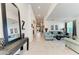 Spacious living room featuring tile flooring, a long hallway, and comfortable furnishings at 5811 Campina Pl, Palmetto, FL 34221