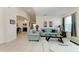 Bright living room featuring neutral walls, tile floors, and comfortable seating arrangement at 5811 Campina Pl, Palmetto, FL 34221