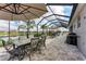 Screened patio with multiple seating areas and tranquil lake views at 5811 Campina Pl, Palmetto, FL 34221