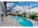 Sparkling pool surrounded by an enclosure, offering a beautiful view of the lake at 5811 Campina Pl, Palmetto, FL 34221