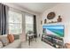 Cozy sitting area with comfortable furniture, neutral decor, and bright natural light from large windows at 5811 Campina Pl, Palmetto, FL 34221