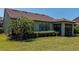 Backyard featuring lush landscaping, manicured lawn, and screened lanai at 5952 Snowy Egret Dr, Sarasota, FL 34238