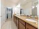 Bathroom featuring granite counters, warm cabinets and a large mirror at 5952 Snowy Egret Dr, Sarasota, FL 34238