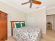 Bedroom featuring a ceiling fan, hardwood floors, and a large closet at 5952 Snowy Egret Dr, Sarasota, FL 34238