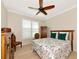 Bedroom featuring a ceiling fan, hardwood floors, and a large window at 5952 Snowy Egret Dr, Sarasota, FL 34238