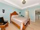 This bedroom boasts hardwood floors, rocking chair, ensuite laundry, and a large bed at 5952 Snowy Egret Dr, Sarasota, FL 34238
