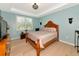 Bright bedroom featuring hardwood floors, a tray ceiling and large window at 5952 Snowy Egret Dr, Sarasota, FL 34238