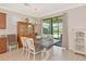 Formal dining area with an elegant light fixture and sliding glass door to lanai at 5952 Snowy Egret Dr, Sarasota, FL 34238