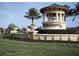Community entrance featuring fountain with a garden and manicured lawn at 5952 Snowy Egret Dr, Sarasota, FL 34238