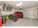 Spacious garage with ample storage and a red Jeep Wrangler at 5952 Snowy Egret Dr, Sarasota, FL 34238