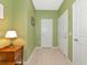Hallway with a side table, lamp, and doors leading to other rooms at 5952 Snowy Egret Dr, Sarasota, FL 34238