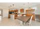 Open-concept kitchen and dining room layout with bright lighting and tile flooring at 5952 Snowy Egret Dr, Sarasota, FL 34238