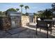 Outdoor kitchen with stone facade, stainless steel appliances and outdoor seating at 5952 Snowy Egret Dr, Sarasota, FL 34238