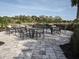 Sandhill Preserve outdoor seating area with multiple tables and chairs overlooking landscaping at 5952 Snowy Egret Dr, Sarasota, FL 34238