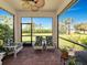 Relaxing screened patio with comfortable seating and views of the lush backyard at 5952 Snowy Egret Dr, Sarasota, FL 34238