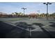 Community tennis court at Sandhill Preserve with lighting and covered seating area at 5952 Snowy Egret Dr, Sarasota, FL 34238