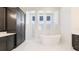 Modern bathroom features a soaking tub, walk-in shower, and dual vanities at 600 Blue Shell Loop, Sarasota, FL 34240