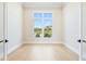 Spacious room with a large window offering a view of the outdoor scenery at 600 Blue Shell Loop, Sarasota, FL 34240