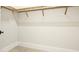 Neutral walk-in closet featuring wooden shelving at 600 Blue Shell Loop, Sarasota, FL 34240