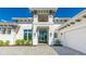 Beautiful home with hardscape driveway and two-story entry with dark trimmed windows and doors at 600 Blue Shell Loop, Sarasota, FL 34240