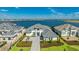 Stunning water view from this home with lush landscaping, hardscaped drive, and grey tiled roof at 600 Blue Shell Loop, Sarasota, FL 34240