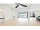 Bright open floor plan with light colored hardwood floors and dark stained ceiling beams at 600 Blue Shell Loop, Sarasota, FL 34240