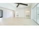 Bright open living room with white walls and trim, light hardwood floors, and tall ceilings at 600 Blue Shell Loop, Sarasota, FL 34240