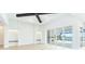 Open living space with light hardwood floors and expansive glass sliders out to the patio and pool at 600 Blue Shell Loop, Sarasota, FL 34240