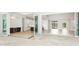 Open-concept living space with hardwood floors and sliding glass doors that provide access to outdoor living at 600 Blue Shell Loop, Sarasota, FL 34240
