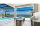 Outdoor kitchen with grill and views of the pool and lake at 600 Blue Shell Loop, Sarasota, FL 34240