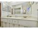 Bathroom featuring an extended vanity with double sinks, and a large mirror at 6004 10Th Ave W, Bradenton, FL 34209