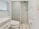 Bathroom featuring a toilet and a glass-enclosed shower at 6004 10Th Ave W, Bradenton, FL 34209
