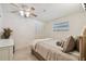 Bedroom with neutral walls, ceiling fan, and a small window and closet at 6004 10Th Ave W, Bradenton, FL 34209