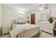 Bedroom features neutral walls, ceiling fan, and ensuite access to bathroom at 6004 10Th Ave W, Bradenton, FL 34209