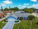 Charming single-story home with a well-manicured lawn, blue siding, and an attached two-car garage at 6004 10Th Ave W, Bradenton, FL 34209