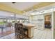 Open kitchen with breakfast bar, white appliances, and easy access to lanai at 6004 10Th Ave W, Bradenton, FL 34209