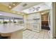 Spacious kitchen featuring a breakfast bar, white appliances, and tile floors at 6004 10Th Ave W, Bradenton, FL 34209