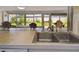 Close-up of kitchen sink with countertop overlooking the lanai and backyard at 6004 10Th Ave W, Bradenton, FL 34209