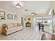 Comfortable living room with tile flooring, leading to the kitchen and enclosed lanai at 6004 10Th Ave W, Bradenton, FL 34209