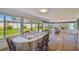 Spacious sunroom featuring tiled floors, glass windows, and view of the fenced backyard at 6004 10Th Ave W, Bradenton, FL 34209