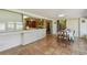 Tiled sunroom featuring view into the kitchen and a dining area at 6004 10Th Ave W, Bradenton, FL 34209