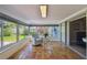 Bright sunroom with tiled flooring, large glass windows and comfortable seating area at 6004 10Th Ave W, Bradenton, FL 34209