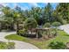 Nicely landscaped backyard with outdoor kitchen, pergola, and lush greenery at 6015 S Elkins Ave, Tampa, FL 33611
