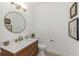 Contemporary bathroom with a wood vanity, modern mirror, and updated fixtures at 6015 S Elkins Ave, Tampa, FL 33611