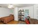 Inviting bedroom with wood floors, complemented by natural light and a comfortable seating area at 6015 S Elkins Ave, Tampa, FL 33611