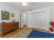 Bright bedroom with white walls, hardwood floors, and a classic mid-century modern dresser at 6015 S Elkins Ave, Tampa, FL 33611