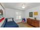 bedroom with hardwood flooring and plantation shutters at 6015 S Elkins Ave, Tampa, FL 33611