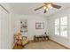 Cozy bedroom with hardwood floors, built-in shelving, and a charming accent chair at 6015 S Elkins Ave, Tampa, FL 33611